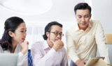 Pensive coworking businesspeople in office